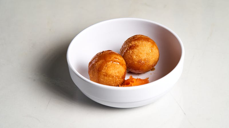 Golden arancini rice balls with tomato dipping sauce