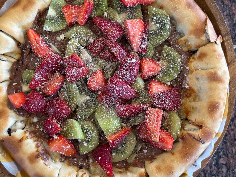 Dessert pizza with Nutella, strawberries, and powdered sugar